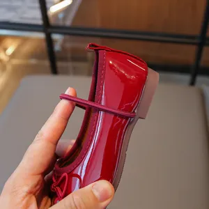 Red patent leather girl's Mary Jane shoes with bow detail for toddlers
