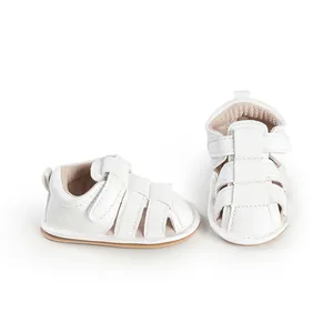 Detail view showing white breathable faux leather baby sandals with secure velcro straps