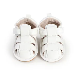 Close-up front view of white breathable baby sandals with adjustable velcro straps