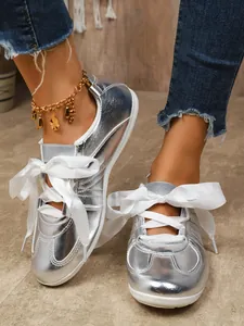 Fashionable silver metallic retro sneakers with elegant white ribbon laces for women