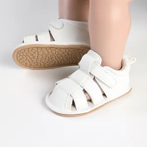 Close-up of white breathable baby sandals on doll feet with anti-slip sole detail