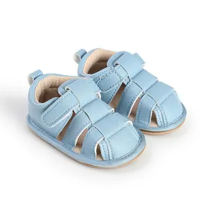 Close-up view of light blue breathable baby summer sandals and soft pre-walker shoes