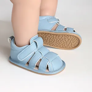 Macro view of light blue baby sandals showing the soft non-slip sole and velcro straps
