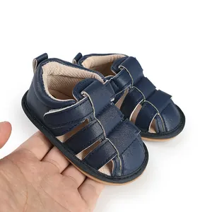Detailed view of navy blue breathable baby sandals with velcro strap design