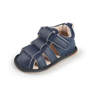 Detailed macro view of navy blue breathable leather baby sandals with soft pre-walker soles