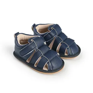 Close-up detail of navy blue soft-sole baby sandals with breathable design and hook loop closure