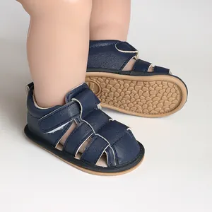 Close-up of navy blue baby sandals showing breathable cut-outs and soft textured grip soles.