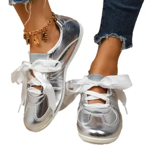 Silver metallic women's German army trainers with elegant white ribbon bow laces stylish