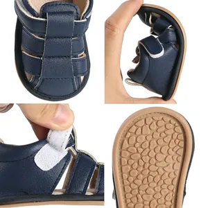 Detail of soft-soled navy baby sandals showing flexibility and non-slip rubber sole