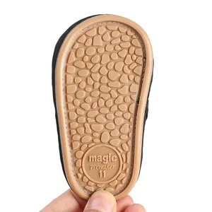 Close-up of non-slip rubber sole with pebble pattern on baby prewalker shoe