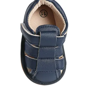 Top-down macro detail of navy blue baby sandal showing breathable faux leather texture