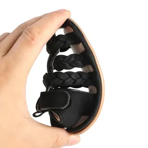 Close-up of flexible black braided baby sandals showing the soft and bendable sole