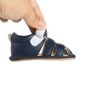 Detailed view of dark navy blue baby sandal featuring a convenient adjustable velcro strap
