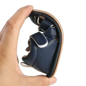 Close-up showing the extreme flexibility and soft sole of the baby sandal
