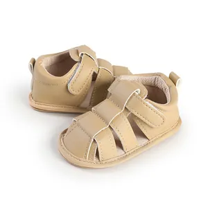 Detail view of breathable khaki baby sandals with hook and loop closure straps