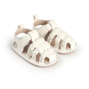 Macro view of white braided baby sandals with adjustable velcro strap for infants