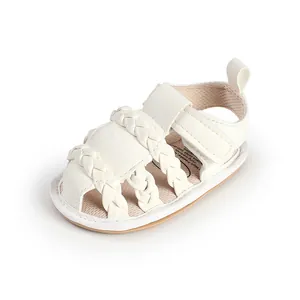 Detail view of white breathable baby sandals with braided straps and velcro strap