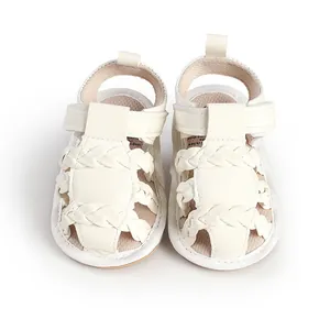 Detailed view of white braided baby sandals with soft soles and breathable design