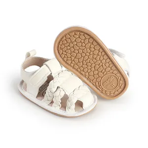 Close-up view of white braided baby prewalker sandals featuring a non-slip rubber sole