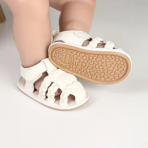Detail of white braided baby sandals with soft non-slip sole and hook-and-loop closure