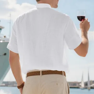 Back view of a white linen short sleeve shirt with stand collar in a yacht setting