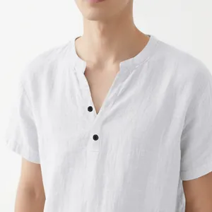 Close-up detail of men's white linen short sleeve shirt with stand collar and buttons