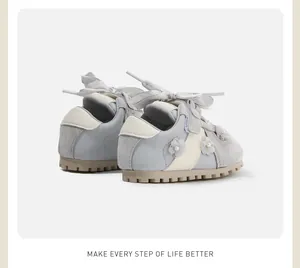 Detailed back view of toddler girls' walking shoes with flower and bow accents