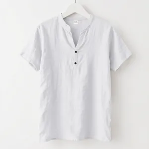 Close-up of a light gray linen shirt featuring a stand collar and button neckline