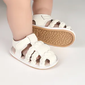 Close-up detail of white braided baby sandals with durable non-slip rubber soles