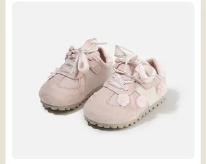Pink toddler walking shoes with ribbon laces and flower details