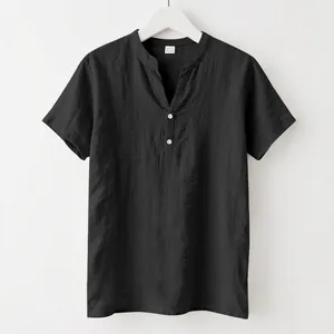 Macro detail of a minimalist black linen short-sleeved shirt with stand collar