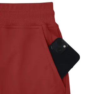 Detailed view of the functional deep pocket on red heavy cotton joggers for men