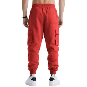 Back view of heavy red cargo joggers with multi-pockets and elastic cuffs.