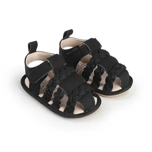 Detailed view of black braided baby sandals with breathable design and velcro