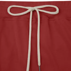 Close-up detail of red heavyweight casual pants featuring a ribbed waistband and drawstring