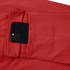 Macro view of the large side pocket on these red heavy cargo pants with a smartphone