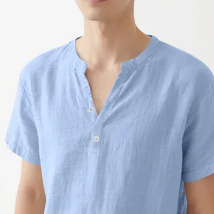 Detail of a light blue linen short sleeve shirt with a buttoned standing collar for men