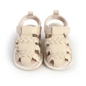 Detailed view of beige braided baby sandals featuring soft soles for walking support