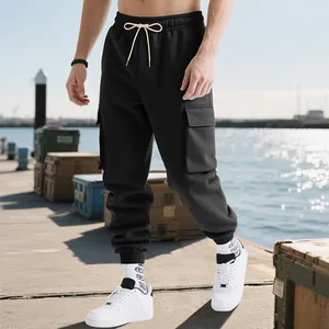 Outdoor view of men's heavyweight black cargo joggers with multi-pocket high street style