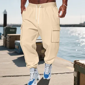 Detail view of men's beige cargo joggers with large pockets and drawstring waist