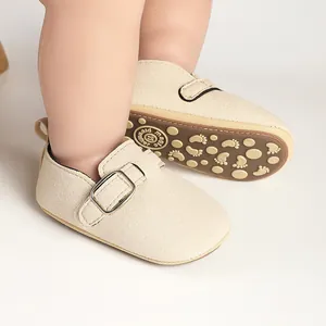 Detailed view of cream baby matte buckle shoes showing the soft texture and sole pattern