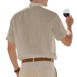 Men's loose beige linen shirt with stand collar shown from back view with wine glass