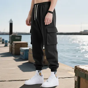 Detail of black heavy weight cargo jogger pants for men with functional multi-pockets.