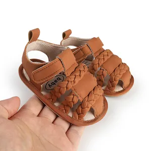 Woven brown breathable soft-soled baby sandals for infants 0-12 months shown in hand