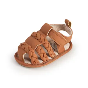 Detail shot of brown braided baby sandals featuring soft breathable lining and velcro strap