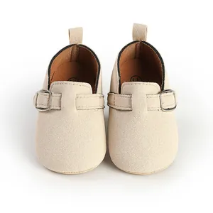 Detailed front view of retro matte beige baby loafers with a classic buckle strap