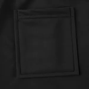 Detailed macro view of a heavy fabric square patch pocket on black high-street cargo pants