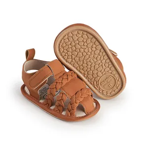 Detailed view of brown braided baby sandals showing non-slip sole and strap design.