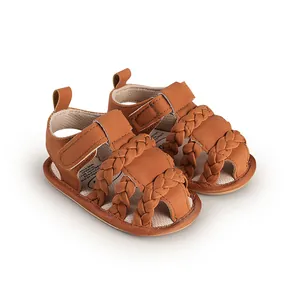 Macro view of brown braided baby sandals featuring breathable faux leather texture