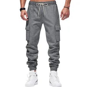 Detailed front view of grey cargo sweatpants with cream drawstrings and side pockets